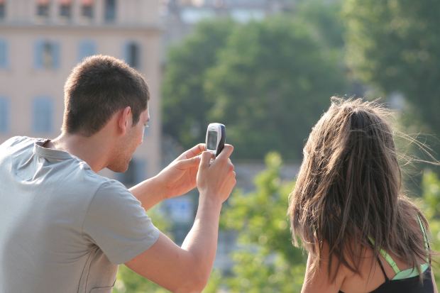 Boyfriend Taking Mobile Photo of Girlfriend