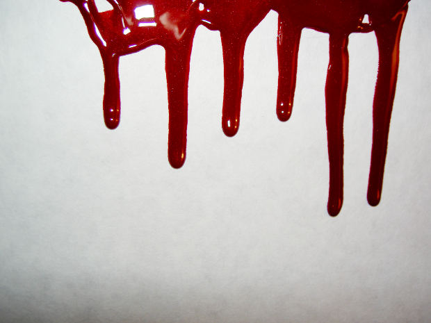 Red color blood dripping on the white wall