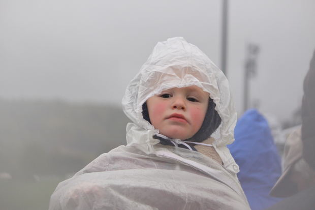 Boy in Rain with plastic cover